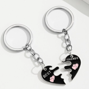 Matching Best Friends heart-shaped puzzle keychains with black enamel and pink heart detail