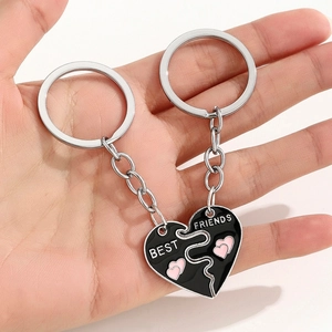 Macro shot of two-piece Best Friends split heart keychains in black enamel finish