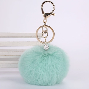 Mint green faux rabbit fur pom pom keychain with gold clasp and rhinestone ball charm