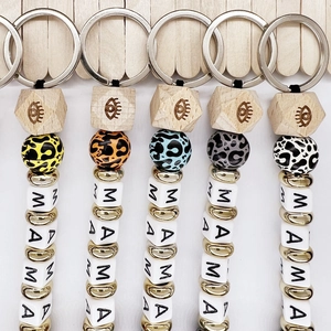 Five MAMA beaded keychains with leopard print wood beads and silver metal rings