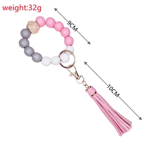 Detail of beaded wristlet keychain with pink tassel and gold metal lobster clasp