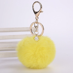 Bright yellow faux rabbit fur keychain with sparkling rhinestone ball and gold metal clip