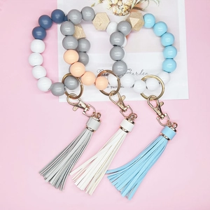 Silicone and wooden bead wristlet keychain with leather tassel in three pastel colors