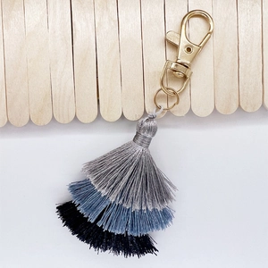 Detail of three-tier gradient cotton fringe keychain with golden lobster clasp and rings