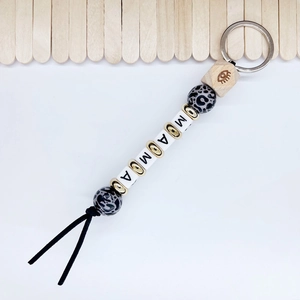 Detail of beaded keychain with leopard print, MAMA letter cubes and hexagon wood bead