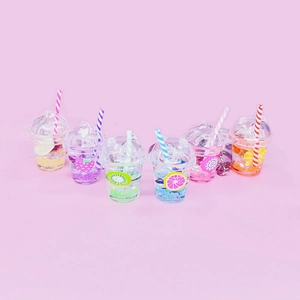 Detailed view of six colorful fruit tea cup keychains with liquid glitter and straws