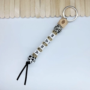 Detail view of MAMA beaded keychain with leopard wood beads and hex eye bead accent