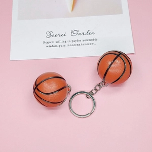 Close-up of mini basketball keychain with textured rubber surface and metal ring details