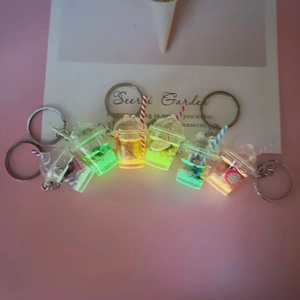 Luminous fruit tea cup keychain set showing glowing liquid and miniature fruit slices