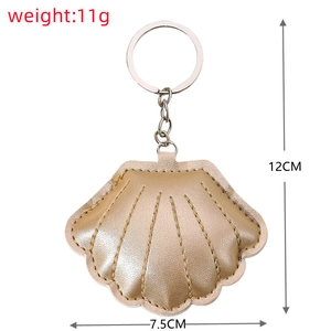 Detail view of 11g gold shell keychain with PU leather texture and precise dimensions