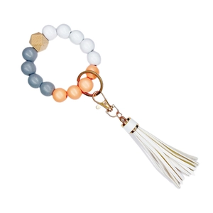 Beaded wristlet keychain with colorful silicone beads, wood bead, and white leather tassel