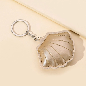 Elegant gold shell keychain made of quilted PU leather with a silver metal keyring