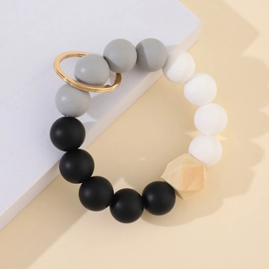 Silicone and wood bead keychain bracelet with black, grey, white beads and gold metal ring