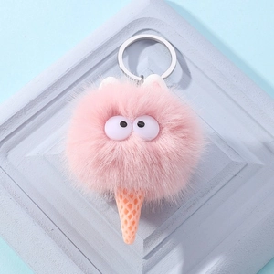 Detailed close-up of a plush ice cream keychain with fuzzy pink top and large eyes