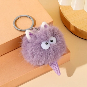 Close-up of purple plush ice cream keychain with fuzzy texture and cute large eye detail