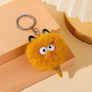 Cute yellow plush monster ice cream keychain with waffle cone and big round eyes on a stand