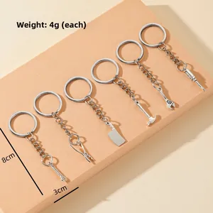 Macro detail of 6-piece mini hardware tool keychains including wrench and hammer