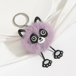 Detail of purple plush raccoon keychain featuring soft fur texture and silver metal ring