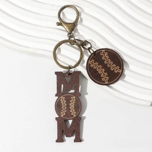 Close-up of wooden MOM keychain with baseball engraving and bronze hardware detailing