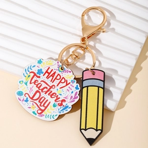 Detail of teacher gift keychain with colorful floral plaque and yellow pencil pendant