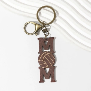 Macro view of vertical wooden volleyball MOM keychain with bronze metal ring and lobster clasp