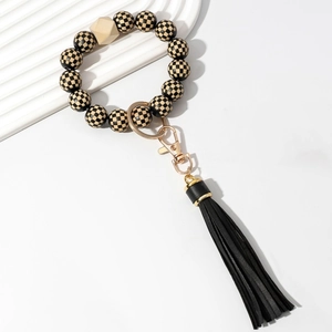 Beaded wristlet keychain with black checkered pattern, wooden bead, and black tassel