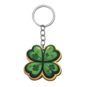 Detail of green shamrock keychain with gold border and four-leaf clover pattern print