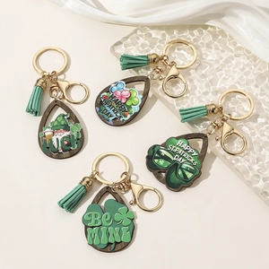 Detailed set of wooden St. Patrick's Day shamrock keychains with green tassels and gold rings