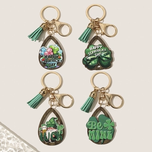 Set of St. Patrick's Day wood keychains with shamrock prints and mint green tassels