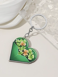 Close-up of heart-shaped St. Patrick's Day keychain with green floral clover pattern