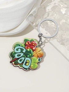 Detail of St. Patrick's Day clover keychain with GOOD lettering on white background