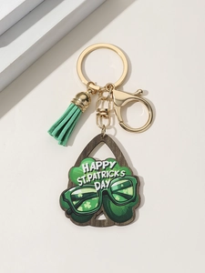 Detail of St. Patrick's Day keychain with green tassel and shamrock wood pendant