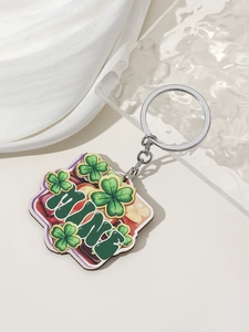 Detailed shot of St. Patrick's Day acrylic keychain with green clover patterns and MINE text