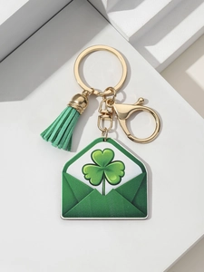 Detail of St. Patrick's gold keychain with green tassel and clover lucky envelope charm