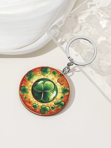Detail of round Saint Patrick's Day keychain with green clover patterns on white satin