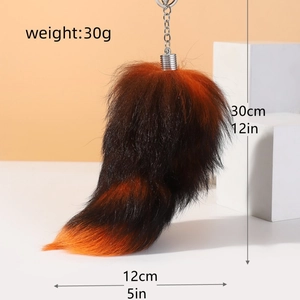 Detailed size view of the 30cm faux fox tail keychain with orange and black fur gradient