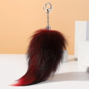 Plush faux fox tail keychain with red and black gradient fur and silver metal ring