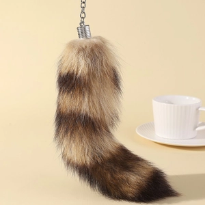 Cute faux fur fox tail keychain with black and yellow stripes and silver metal clasp link