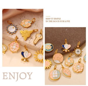 Macro detail of assorted gold enamel charms with celestial sun and moon motifs for DIY
