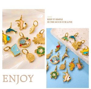 Macro detail of colorful enamel gold ocean charms featuring starfish and sea shells