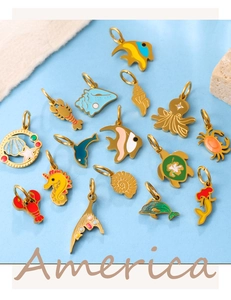Detailed macro shot of 15 various gold enamel marine ocean-themed charm pendants