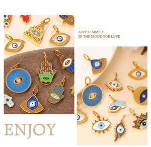 Detailed view of gold Hamsa hand and Evil Eye enamel pendants with sparkling rhinestones