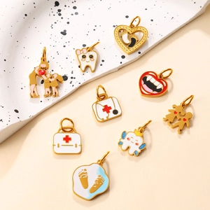 Pendentifs émaillés dorés avec trousse de secours et dents pour création de bijoux
