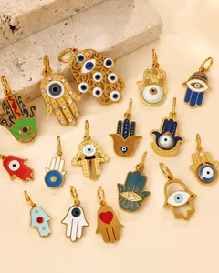 Detail of golden Hamsa Hand pendants with colorful enamel devil eye and rhinestone accents