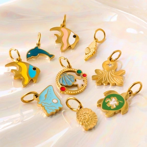 Golden ocean theme charms set including starfish, dolphin and seashell pendants
