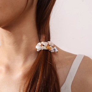 Chic beige pleated scrunchie with porcelain flower and star charms on ponytail