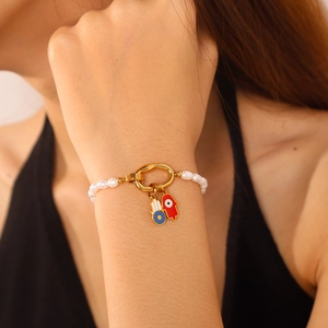 Handmade pearl bracelet with golden Hamsa Hand pendants and Evil Eye enamel charms