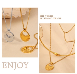 Macro detail of gold and silver minimalist geometric pendants with wavy texture finish