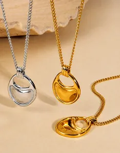 Detailed macro view of minimalist hollow geometric pendants in gold and silver finish