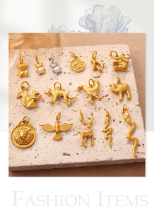 Detailed view of gold animal pendants including bear and rabbit with pearl accents